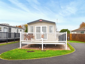 A mobile home with a white exterior, a balcony, and a number 23 sign. - This three-bedroom lodge at Beverley Holiday Park, Paignton. (Paignton)