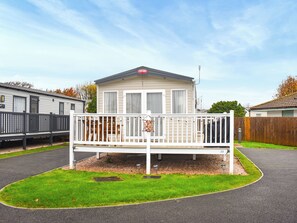 A mobile home with a white exterior, a balcony, and a number 23 sign. - This three-bedroom lodge at Beverley Holiday Park, Paignton. (Paignton)