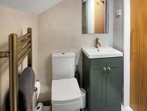 A bathroom with a toilet, sink, and cabinet. - 1 bedroom accommodation in Brompton On Swale, near Richmond (Brompton On Swale, near Richmond)