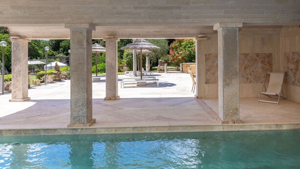 A pool area with clear water, stone columns, and outdoor seating. - Dependance 2 - Holiday Rental with swimming pool on the Tuscan Coastline (Monteverdi Marittimo)