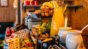 A breakfast buffet with various food items, including fruits, vegetables, and beverages. - Charming Alpine guesthouse for 23 people (Hollersbach im Pinzgau)