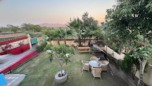 A patio with outdoor furniture, a small table, and a seating area.