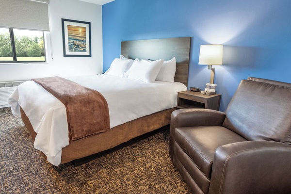 Unwind in crisp linens and relax in a cozy chair.