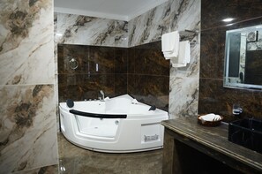 Executive Suite | Bathroom | Hair dryer, slippers, towels, soap