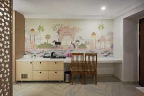 A room with a desk, chair, and a decorative wall mural. - The Forest Hills Resort (Sarada)