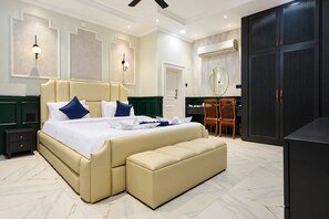 A modern bedroom with a large bed, a desk, and a wardrobe. - The Forest Hills Resort (Sarada)