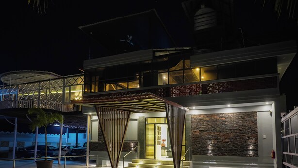 A modern building with a covered entrance, a staircase, and a fire extinguisher. - The Forest Hills Resort (Sarada)