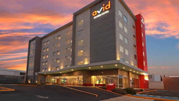 A modern hotel building with a prominent 'Avid' sign, multiple floors, and a parking area. - Avid Hotel Fresnillo (Fresnillo)