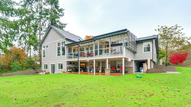 A two-story house with a covered patio area and a large lawn. - Peaceful Patio View! Waterfront Puget Sound Unit (Poulsbo)