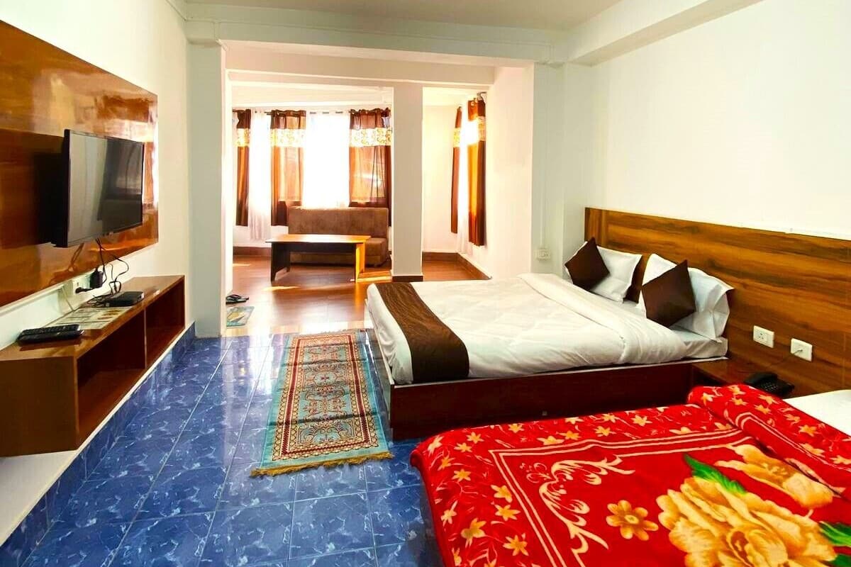 Family Room | Desk, laptop workspace, bed sheets