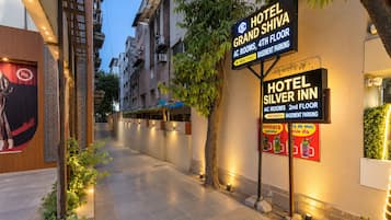 A hotel corridor with signs for Hotel Grand Shiva and Hotel Silver Inn, indicating AC rooms on the 4th and 2nd floors respectively.