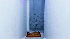 A white staircase leading to a room with a 'WELCOME' mat. - Exclusive 4BR/3BA Penthouse Lux Apartment + Rooftop @ BBB Nation Oasis in Kigali (Kigali)