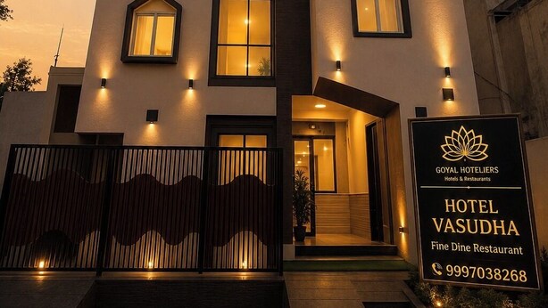 A modern hotel with a prominent entrance, multiple windows, and a sign indicating it is part of the Goyal Hoteliers chain. - Goyal Hoteliers - Hotel Vasudha (Vrindavan)