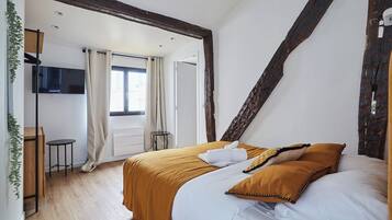 Desk, iron/ironing board, bed sheets