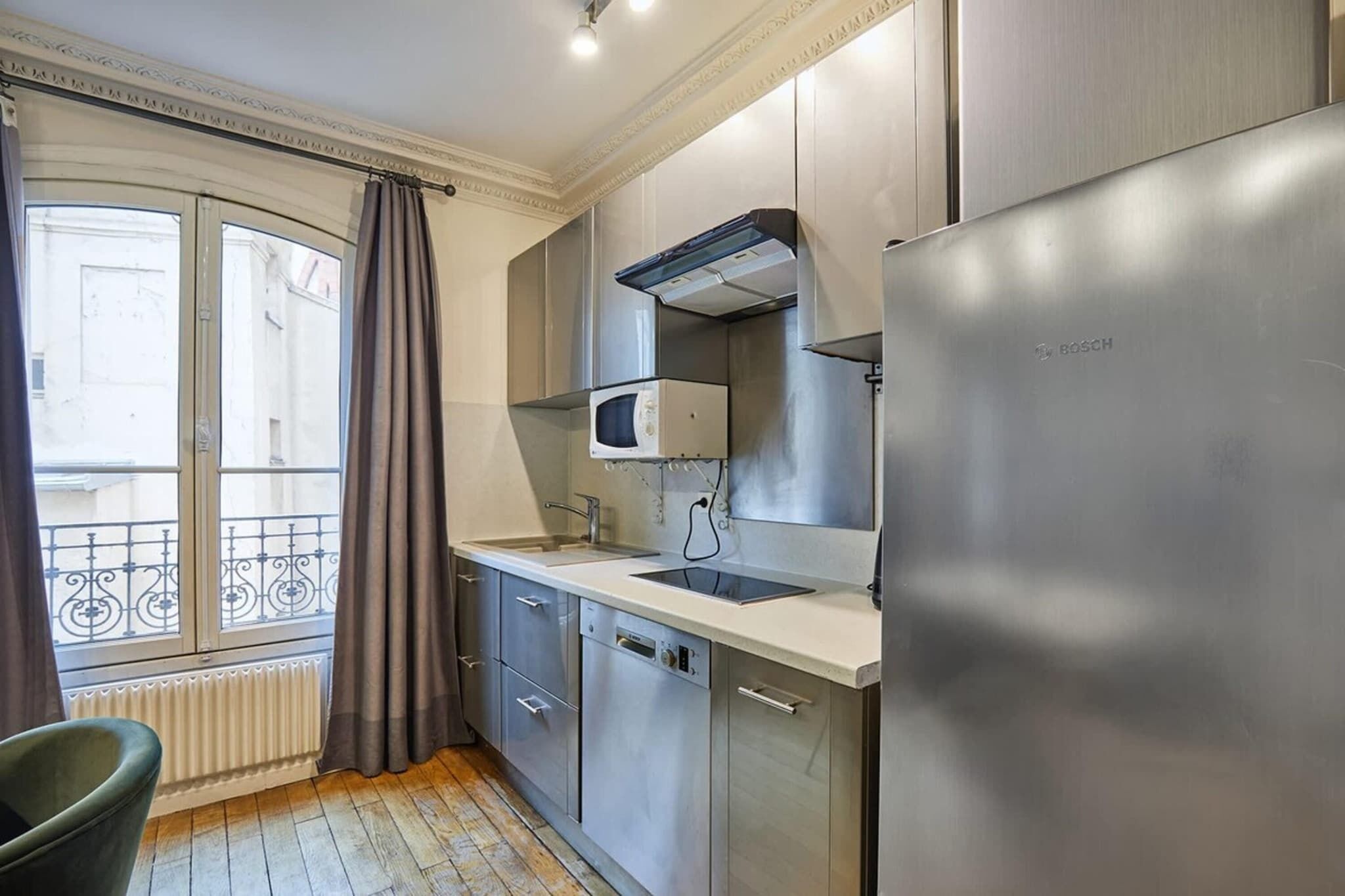 A modern kitchen with stainless steel appliances, a built-in microwave, and a dishwasher.