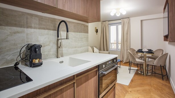 A compact kitchen with a built-in oven, a coffee machine, and a sink. - New apartment Center of Paris/Le Marais (Paris)