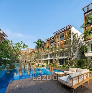 A pool area with lounge chairs and a wooden deck. - InterContinental Residences 2Bedroom IRA (Hua Hin)