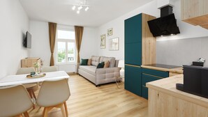A modern kitchen with a built-in stove, a dining area with a table and chairs, and a sofa. - Residence 44 (Prague)