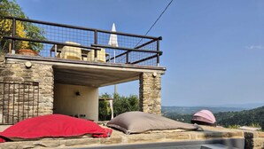A stone building with a pool, red and beige cushions, and a pink dome tent. - Cozy La Lavanda Studio Apartment with private terrace and infinity pool (Merana)