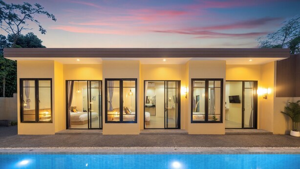 A modern hotel with a swimming pool, large glass doors, and a flat roof. - Amaleena Pool Access, Phuket (Rawai)