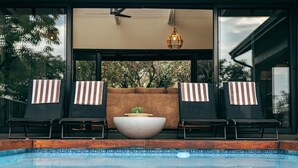 A poolside area with lounge chairs, a large bowl, and a ceiling fan. - Summerplace Game Reserve (Vaalwater)