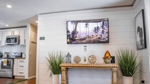 A modern kitchen with white cabinetry, a microwave, and a stove. - Xlnc Exotic Home Sunnyside by sdstay (San Diego)