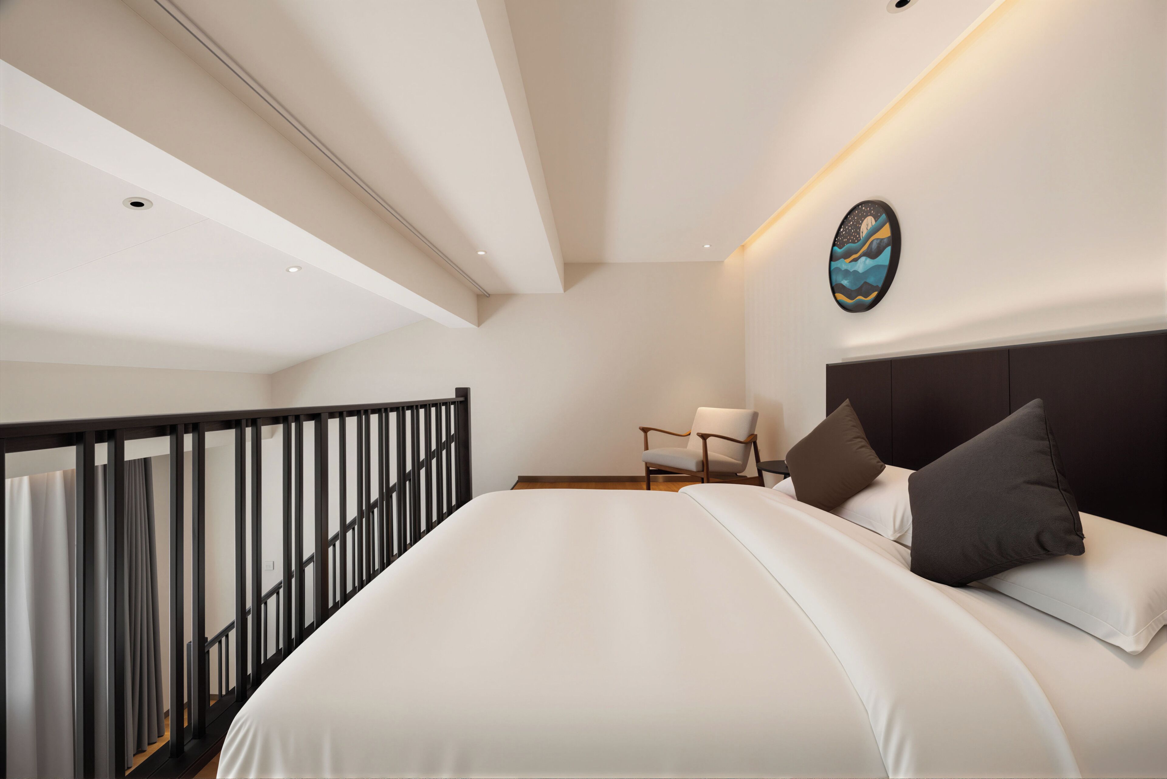 A modern bedroom with a large bed, a chair, and a painting on the wall.