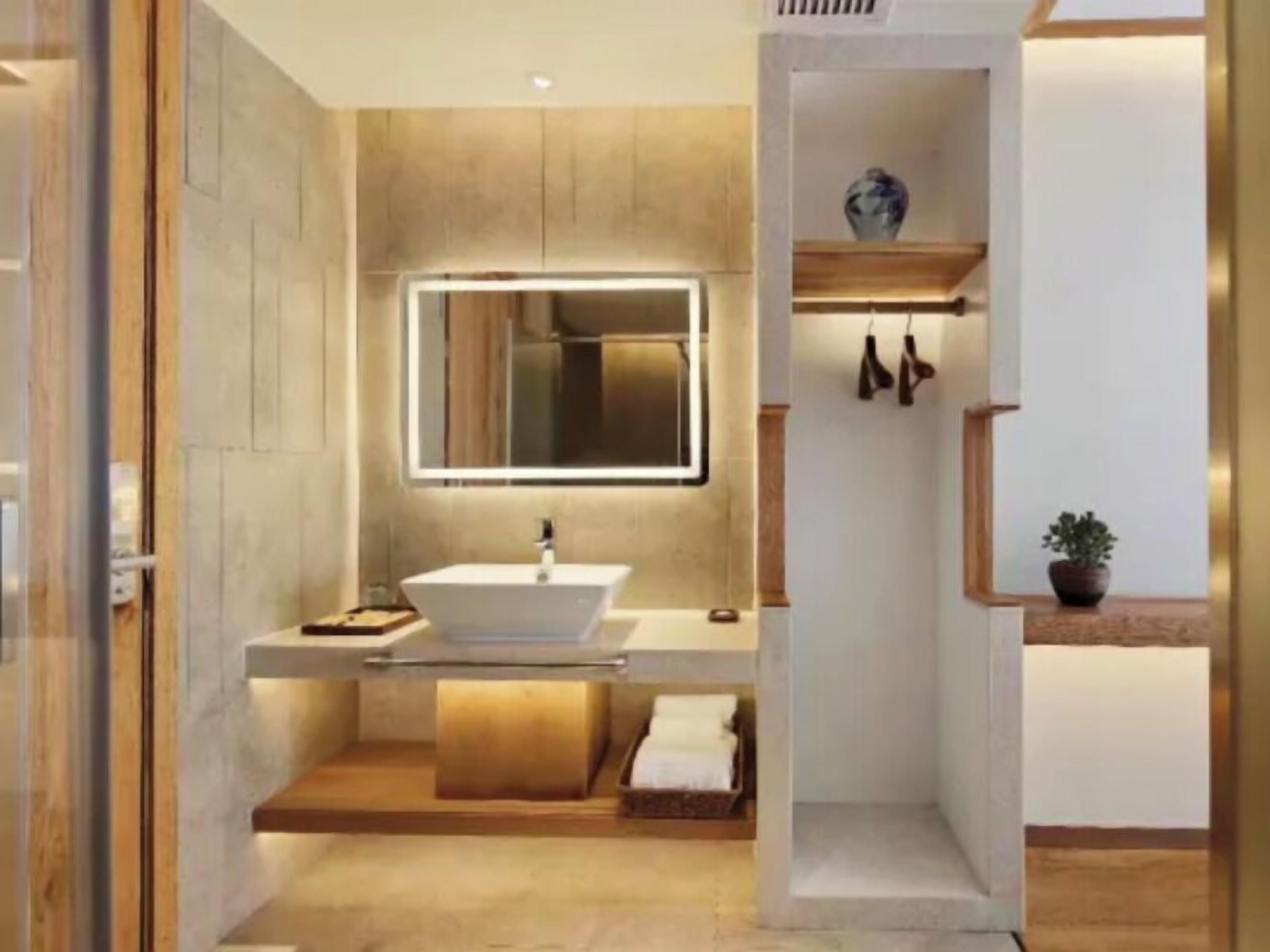 A modern bathroom with a freestanding sink, a mirror, and a towel rack.