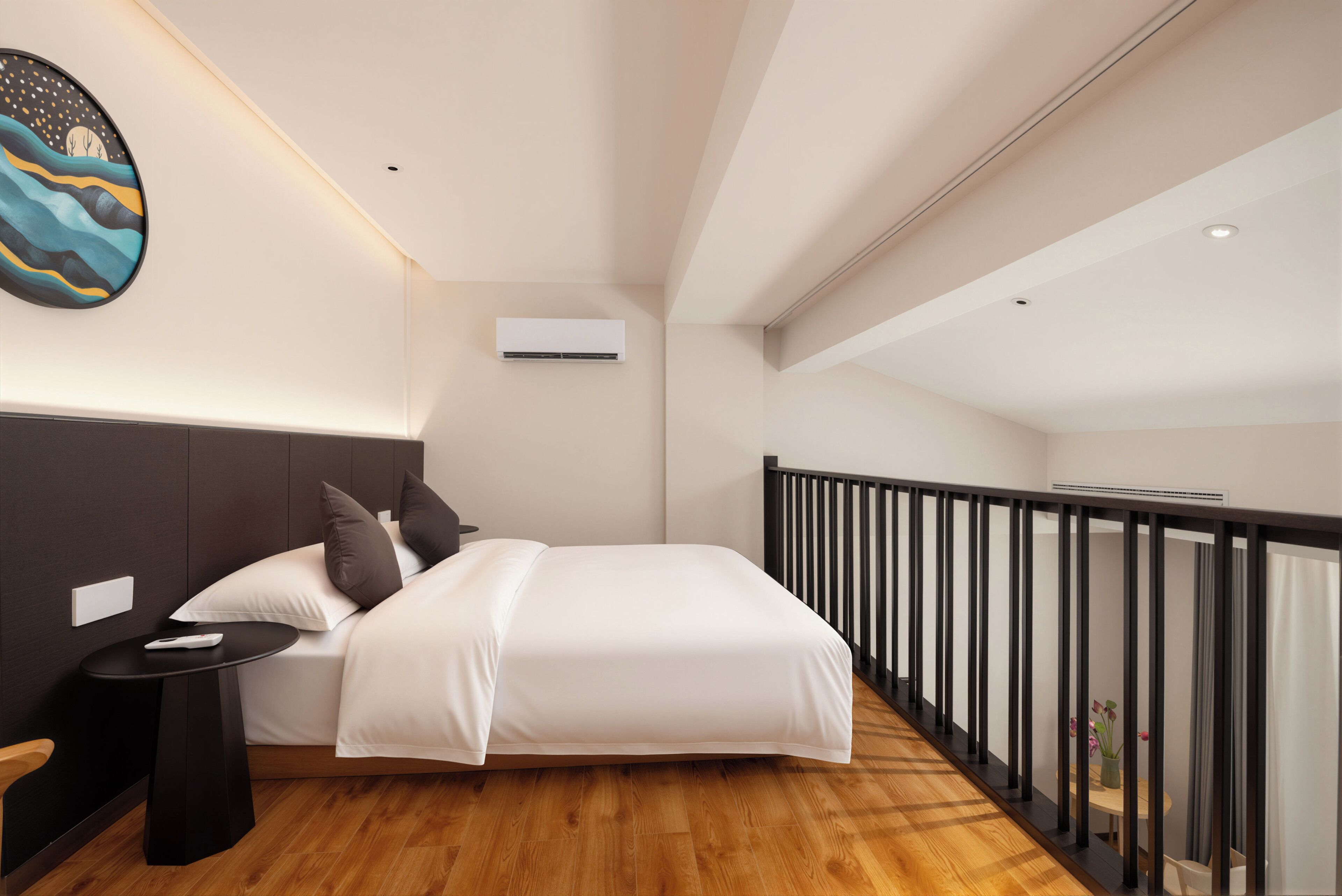 A modern bedroom with a bed, bedside table, and a nightstand.
