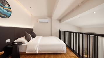 A modern bedroom with a bed, bedside table, and a nightstand.
