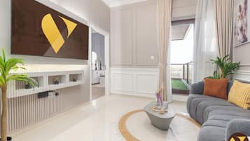 Apartamento superluxo, sacada, vista para a cidade | Área de estar | Smart TV 65 polegadas com canais a cabo