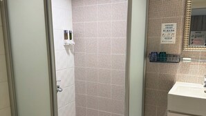 A modern bathroom with a glass-enclosed shower, white tiled walls, a sink, and a toilet. - Ximenhotel Xining (Taipei)