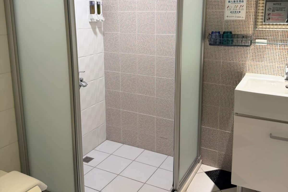 Shower, hair dryer, slippers, towels