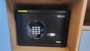 A wooden cabinet with a black safe inside. - Perfect for Digital Nomads | Studio in Condesa (Mexico City)