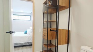 A compact room with a bed, a wooden wardrobe, and a toilet. - Perfect for Digital Nomads | Studio in Condesa (Mexico City)