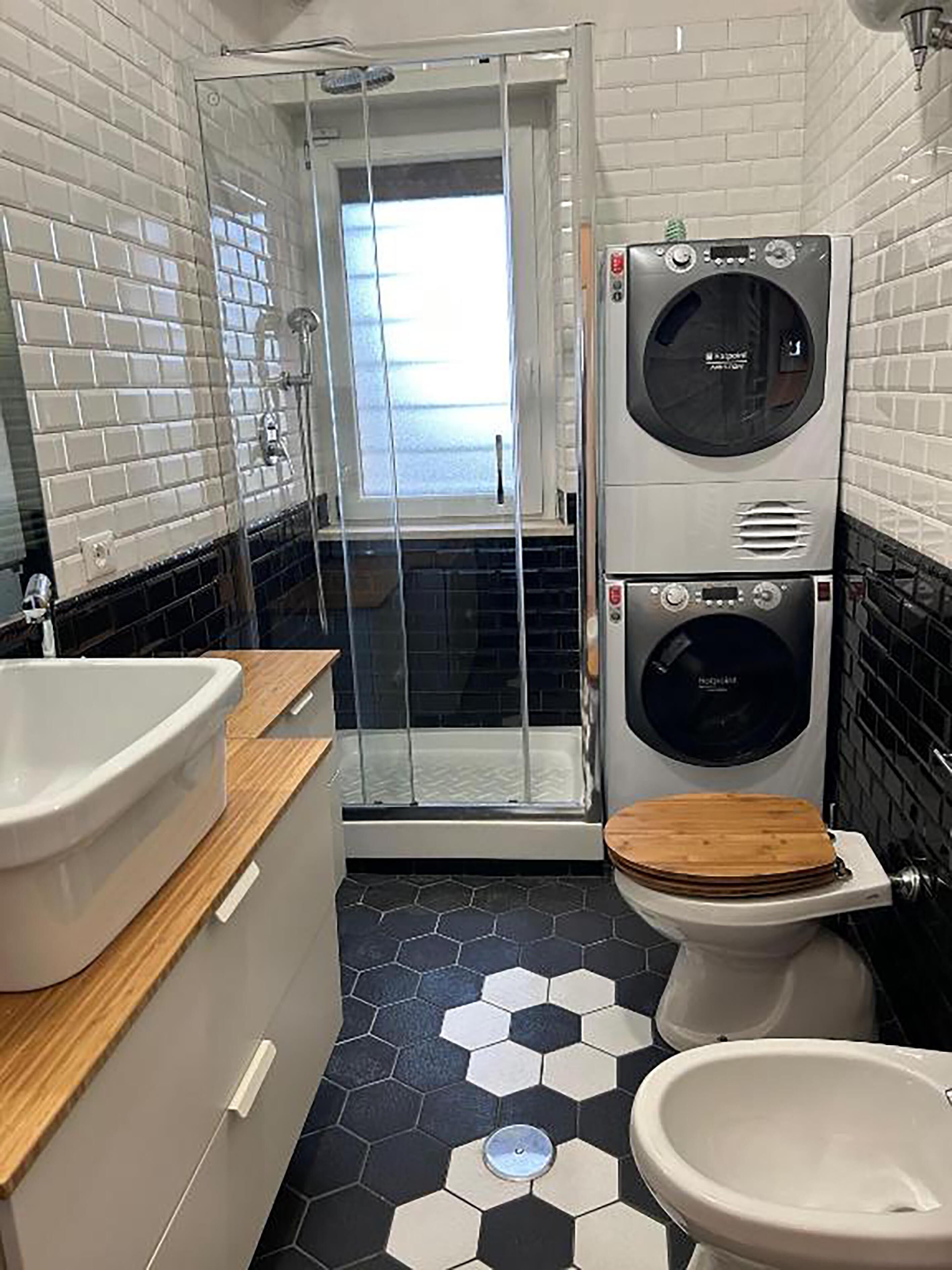 A bathroom with a shower, toilet, and sink.