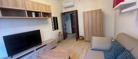 Apartment (1 Bedroom) | Living area | 32-inch flat-screen TV with cable channels