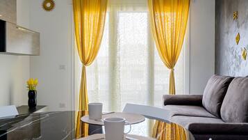 Family Apartment (2 Bedrooms) | Living area | 32-inch flat-screen TV with cable channels