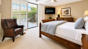 A bedroom with a bed, a chair, a television, and a ceiling fan. - Harvard Hideaway: sun-splashed, westerly views in The Springs Country Club. Managed by Greenday! (Rancho Mirage)