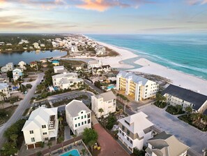 A coastal resort area with beachfront properties, a marina, and a large hotel with multiple floors.