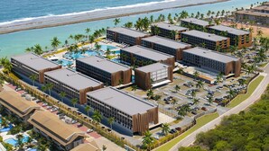 A resort with multiple buildings, a swimming pool, and a beach view. - PORTO 2 LIFE RESORT (Ipojuca)