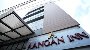 The exterior of AANGAN INN with a modern architectural design, featuring a prominent signboard and large windows. - AANGAN INN (Bhubaneshwar)