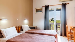 A hotel room with two beds, a small table, a chair, a balcony with curtains, and a painting on the wall. - Pink House Socrates Kerkyra Beachside Studio (Corfu)