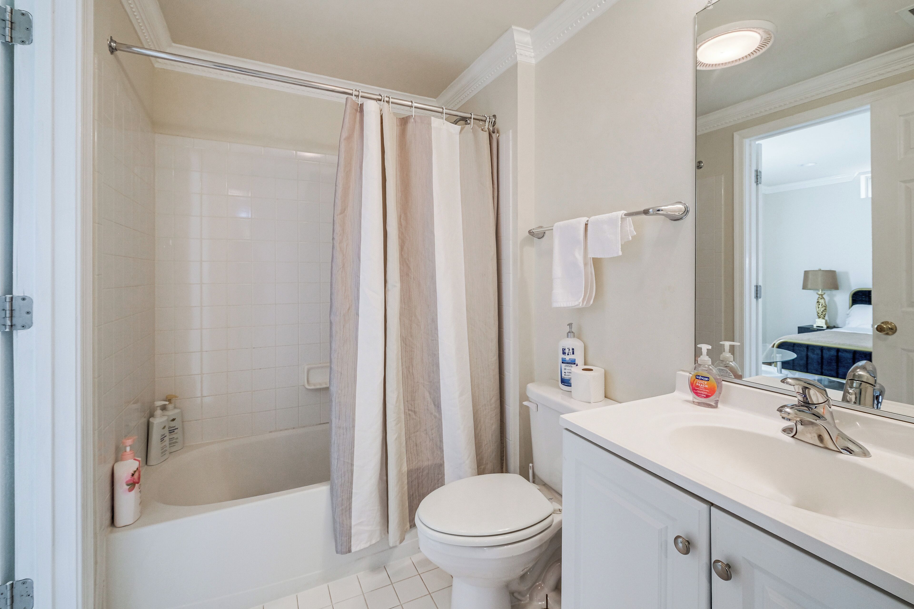 A bathroom with a bathtub, toilet, and sink.