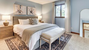 A bedroom with a bed, bedside tables, a bench, a rug, and artwork on the wall. - 4 Mi to Capitol: Spacious Springfield Home w/ Deck (Springfield)
