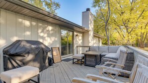 A covered outdoor deck with a barbecue, seating area, and a chimney. - 4 Mi to Capitol: Spacious Springfield Home w/ Deck (Springfield)