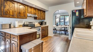 A modern kitchen with wooden cabinets, stainless steel appliances, and a central island. - 4 Mi to Capitol: Spacious Springfield Home w/ Deck (Springfield)