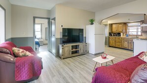 A living room with a TV, sofas, and a small table. - Steps to Shore! Pet-friendly Lake Waconia Getaway (Waconia)