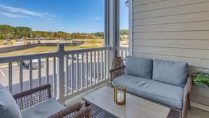 A balcony with a sofa, a table, and a railing. - Family Getaway in Calabash w/ Pool; 9 Mi to Beach (Calabash)