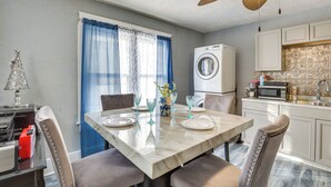 A dining area with a marble table, chairs, and a ceiling fan. - Spacious Condo 4 Mi to Pro Football Hall of Fame! (Canton)
